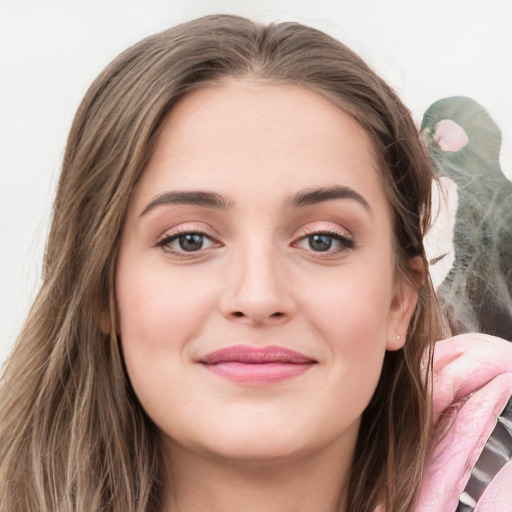 Joyful white young-adult female with long  brown hair and grey eyes