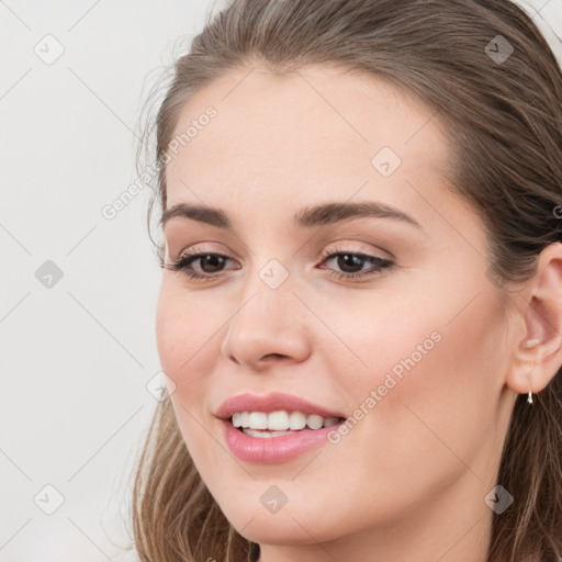 Joyful white young-adult female with long  brown hair and grey eyes