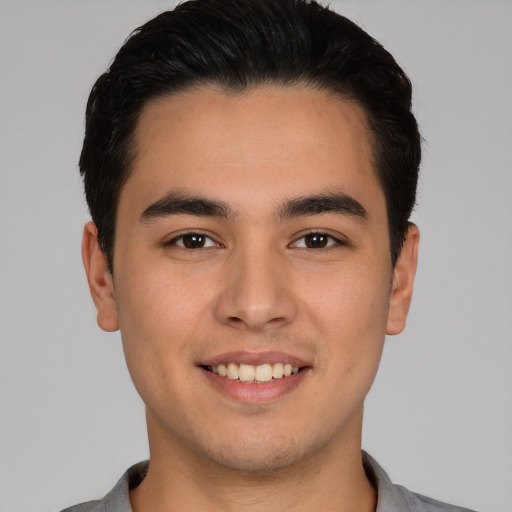 Joyful white young-adult male with short  black hair and brown eyes