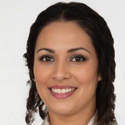 Joyful latino young-adult female with long  brown hair and brown eyes