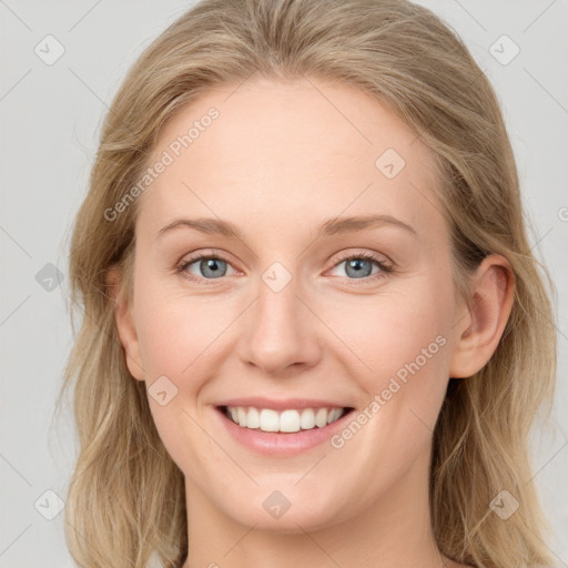 Joyful white young-adult female with long  brown hair and blue eyes