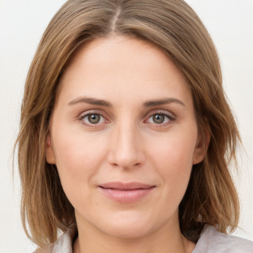 Joyful white young-adult female with medium  brown hair and green eyes