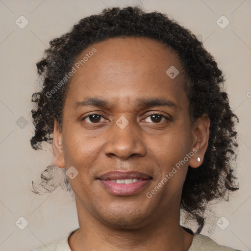 Joyful black young-adult male with short  brown hair and brown eyes