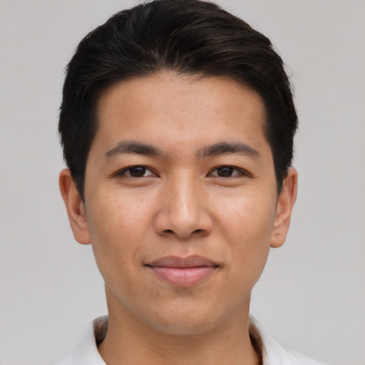 Joyful asian young-adult male with short  brown hair and brown eyes