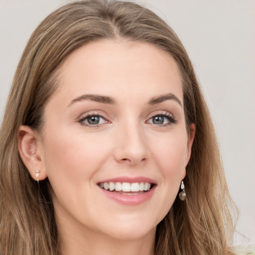 Joyful white young-adult female with long  brown hair and grey eyes