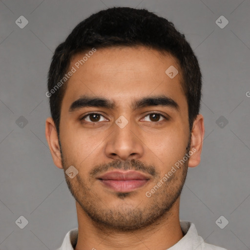 Joyful latino young-adult male with short  brown hair and brown eyes