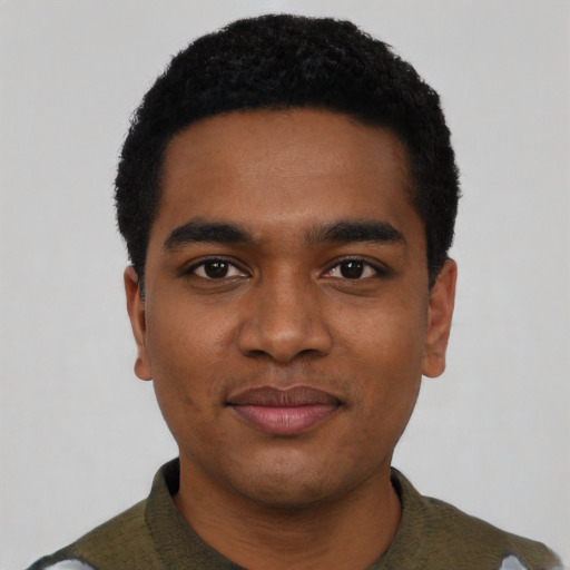 Joyful black young-adult male with short  black hair and brown eyes