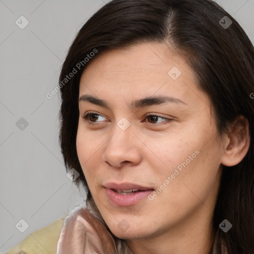 Joyful white young-adult female with long  brown hair and brown eyes