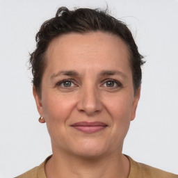 Joyful white adult female with short  brown hair and brown eyes