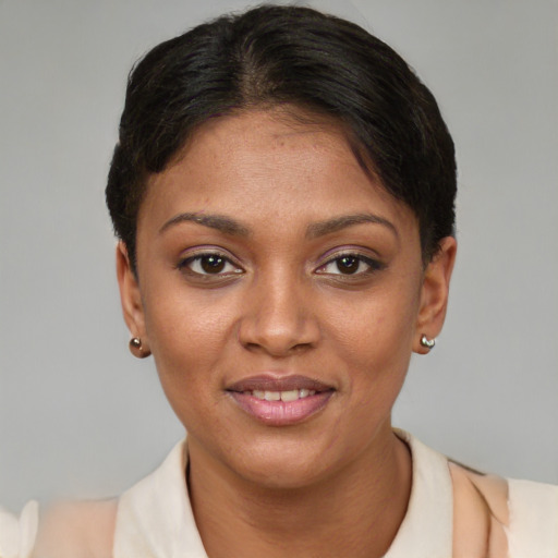 Joyful black young-adult female with short  brown hair and brown eyes