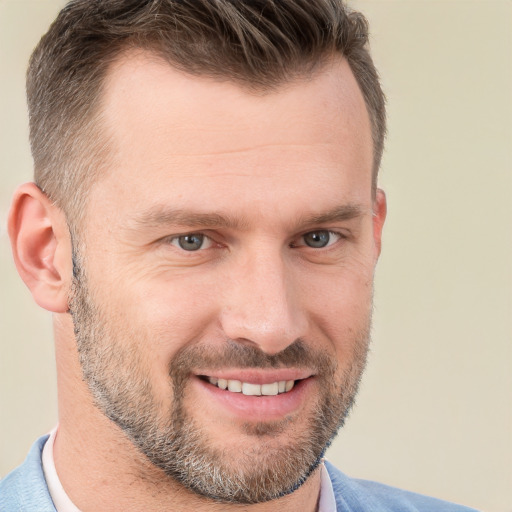 Joyful white adult male with short  brown hair and brown eyes