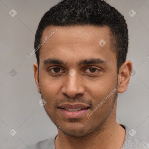 Joyful black young-adult male with short  black hair and brown eyes