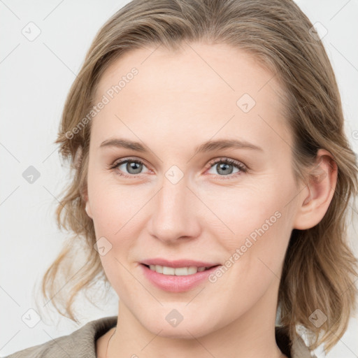 Joyful white young-adult female with medium  brown hair and blue eyes