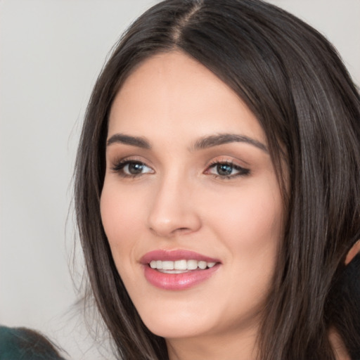 Joyful white young-adult female with long  black hair and brown eyes