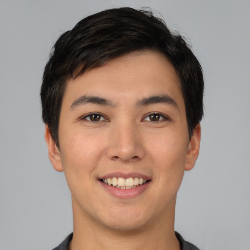 Joyful asian young-adult male with short  black hair and brown eyes