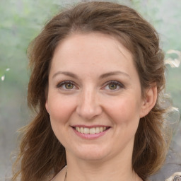 Joyful white young-adult female with medium  brown hair and green eyes