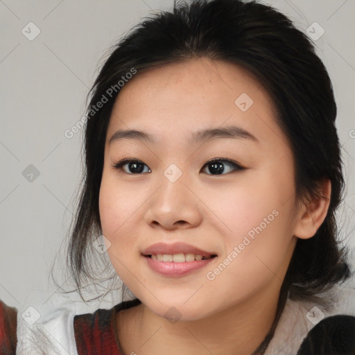 Joyful asian young-adult female with medium  black hair and brown eyes