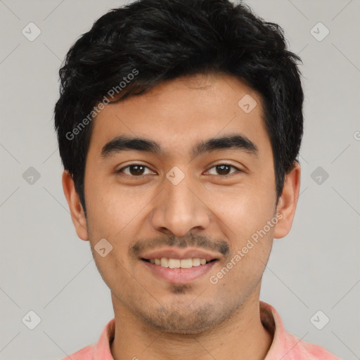 Joyful latino young-adult male with short  black hair and brown eyes