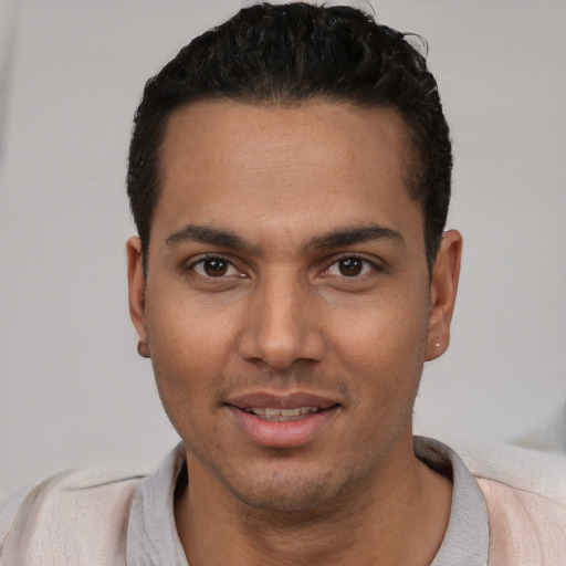 Joyful white young-adult male with short  black hair and brown eyes