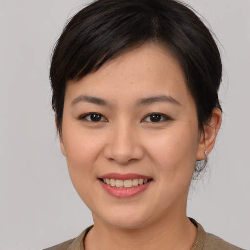 Joyful asian young-adult female with medium  brown hair and brown eyes