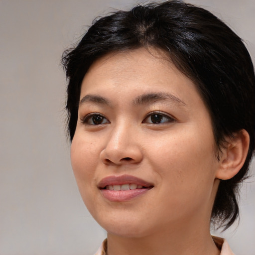 Joyful asian young-adult female with medium  brown hair and brown eyes