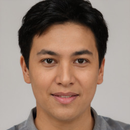 Joyful asian young-adult male with short  black hair and brown eyes