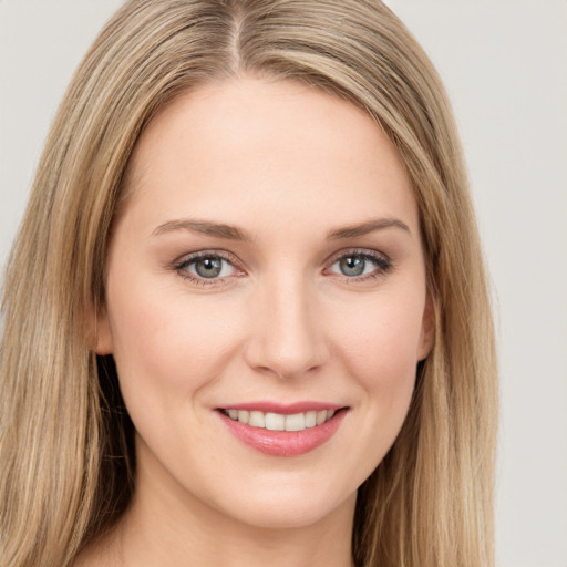 Joyful white young-adult female with long  brown hair and green eyes