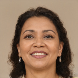 Joyful white adult female with long  brown hair and brown eyes