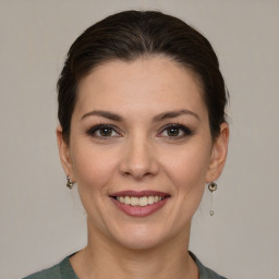 Joyful white young-adult female with medium  brown hair and brown eyes