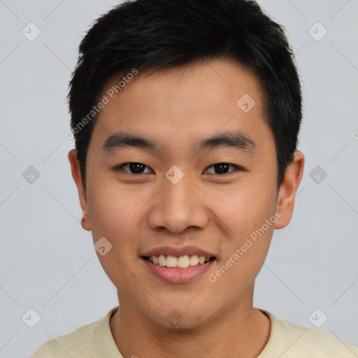 Joyful asian young-adult male with short  black hair and brown eyes