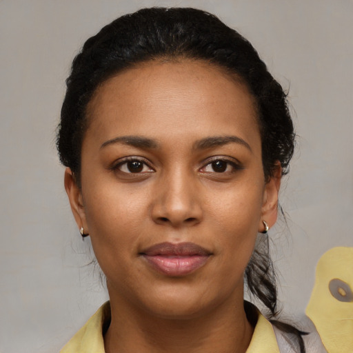 Joyful black young-adult female with short  brown hair and brown eyes