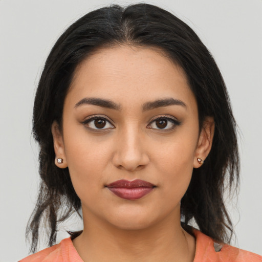 Joyful latino young-adult female with medium  black hair and brown eyes