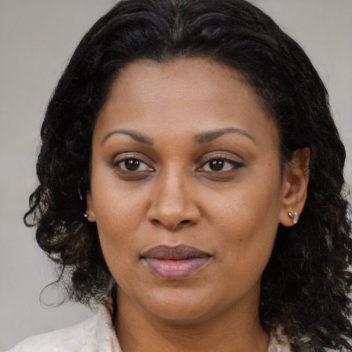 Joyful black adult female with medium  brown hair and brown eyes