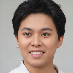 Joyful asian young-adult male with short  brown hair and brown eyes