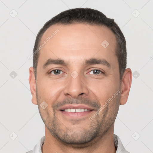 Joyful white young-adult male with short  black hair and brown eyes