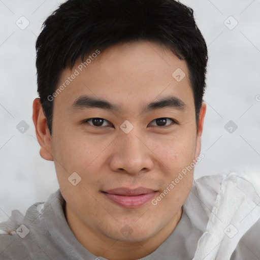 Joyful asian young-adult male with short  brown hair and brown eyes