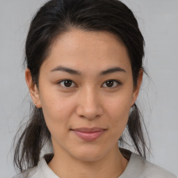 Joyful asian young-adult female with medium  brown hair and brown eyes