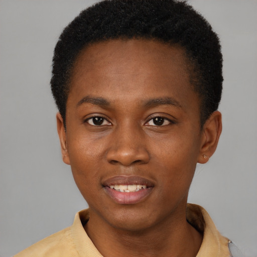 Joyful black young-adult male with short  brown hair and brown eyes