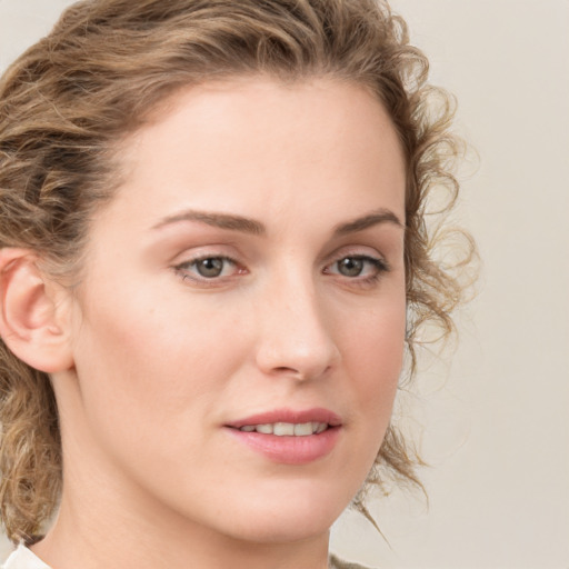 Joyful white young-adult female with medium  brown hair and green eyes