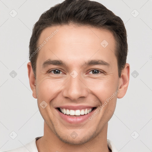 Joyful white young-adult male with short  brown hair and brown eyes