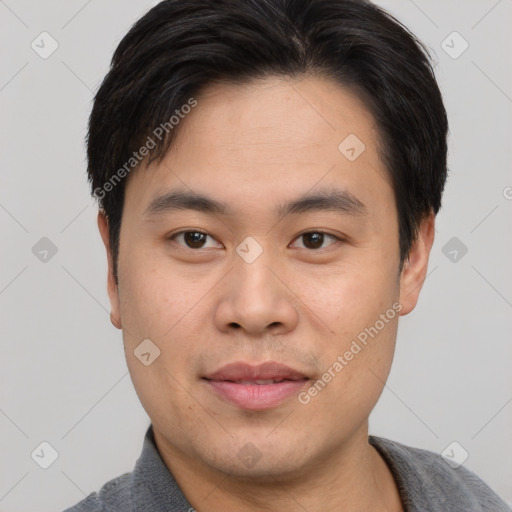 Joyful asian young-adult male with short  brown hair and brown eyes