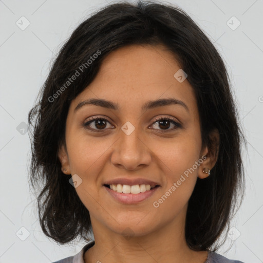 Joyful latino young-adult female with medium  brown hair and brown eyes