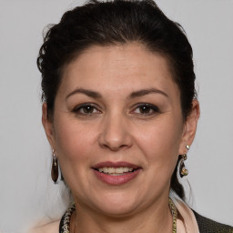 Joyful white adult female with medium  brown hair and brown eyes