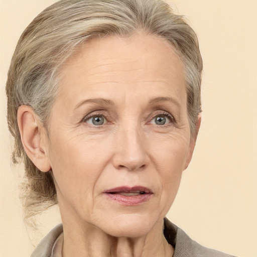 Joyful white middle-aged female with medium  brown hair and grey eyes