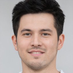 Joyful white young-adult male with short  brown hair and brown eyes