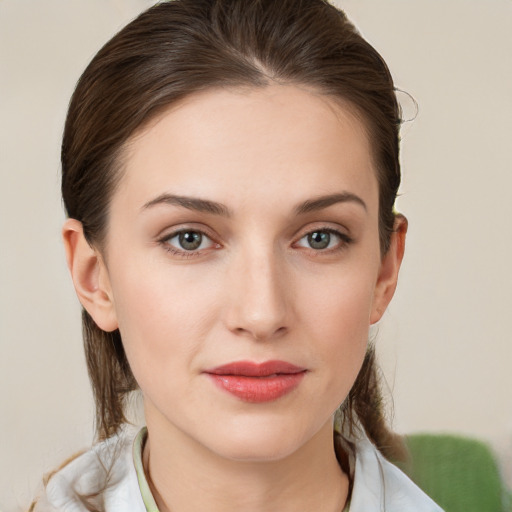 Joyful white young-adult female with medium  brown hair and grey eyes