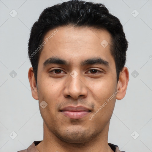 Joyful latino young-adult male with short  black hair and brown eyes