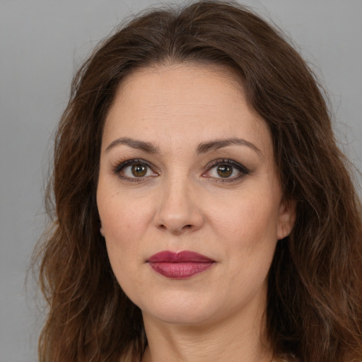 Joyful white adult female with long  brown hair and brown eyes