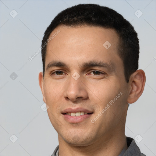 Joyful white young-adult male with short  black hair and brown eyes