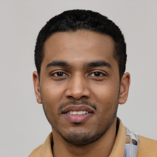 Joyful latino young-adult male with short  black hair and brown eyes